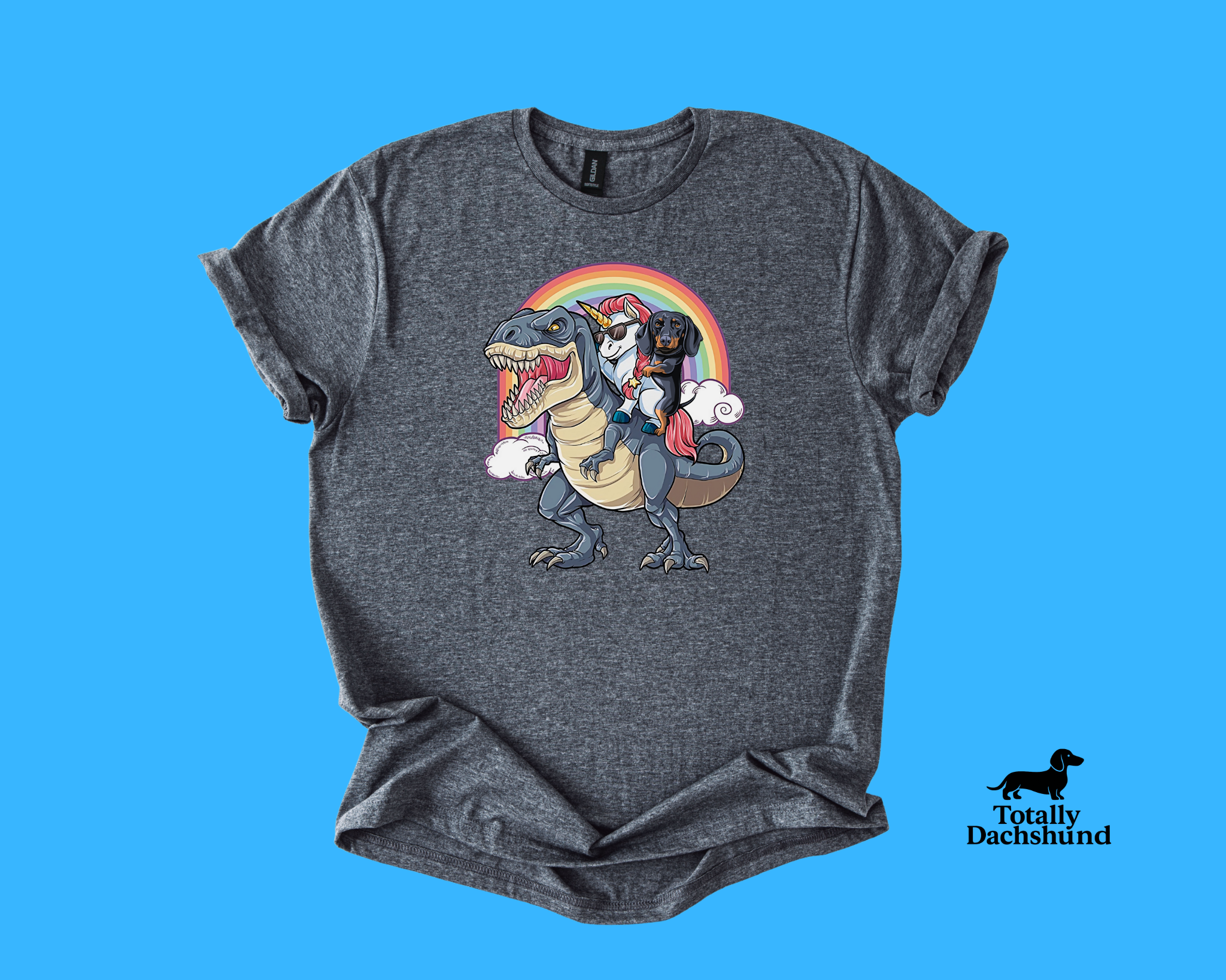 Funny dachshund riding a unicorn with sunglasses on a T-Rex under a rainbow – gray novelty dog shirt