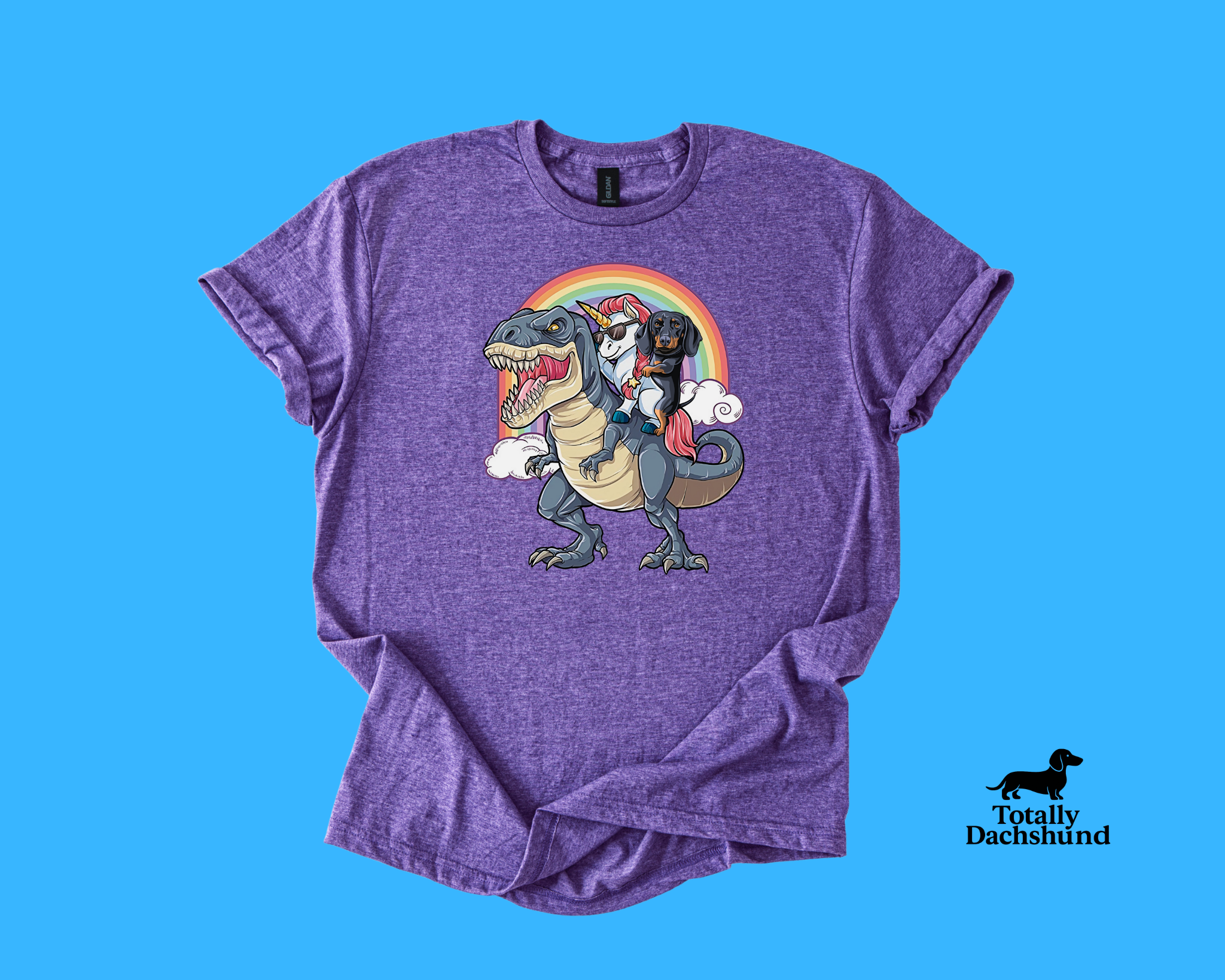 Funny dachshund riding a unicorn with sunglasses on a T-Rex under a rainbow – purple novelty dog shirt